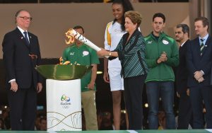 Brazilian President Dilma Rousseff lights the Olympic torch at Planalto Palace in Brasilia AFP PHOTO / EVARISTO SA]